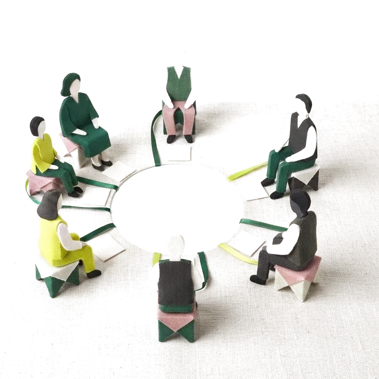 Anonymous paper and fabric figures in an open peer-learning conversation circle.